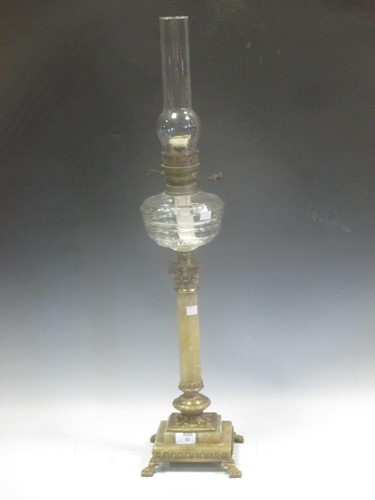 Lot 82 - A brass mounted onyx column oil lamp 86cm high...