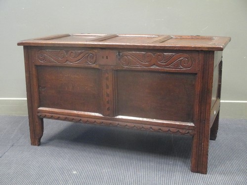 Lot 571 - Circa 1700 a panelled oak coffer with carved...