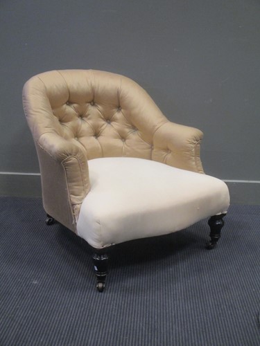 Lot 576 - A late Victorian ebonised button back armchair...