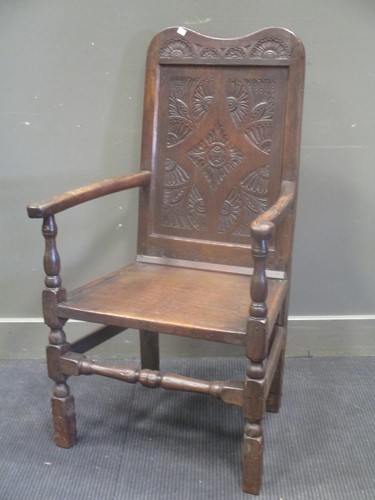 Lot 692 - A 19th century carved oak open armchair