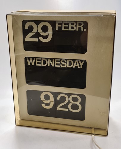Lot 310 - A 1960s flicker clock with calendar, in...