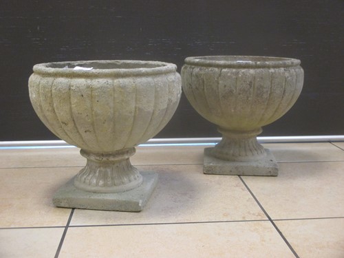 Lot 717 - A pair of composite garden urns, with...