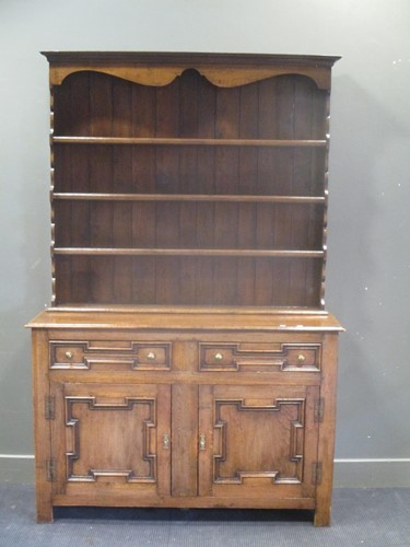 Lot 666 - A George III style oak dresser with plate rack...