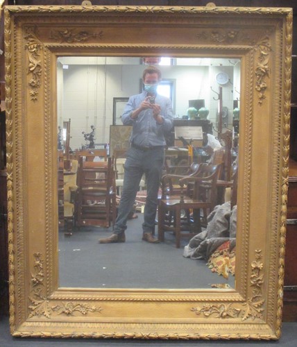 Lot 592 - A large Victorian gilt framed wall mirror with...