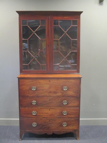 Lot 551 - A George III mahogany secretaire astragal...