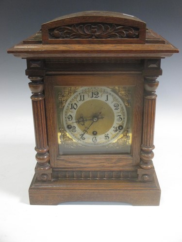 Lot 136 - A late Victorian oak cased mantel clock 39cm high