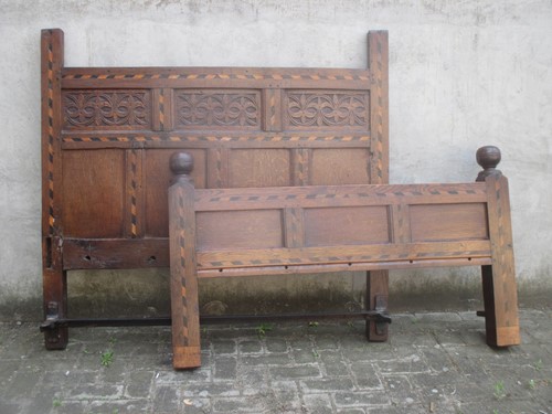 Lot 648 - A 17th century style carved and inlaid oak bed