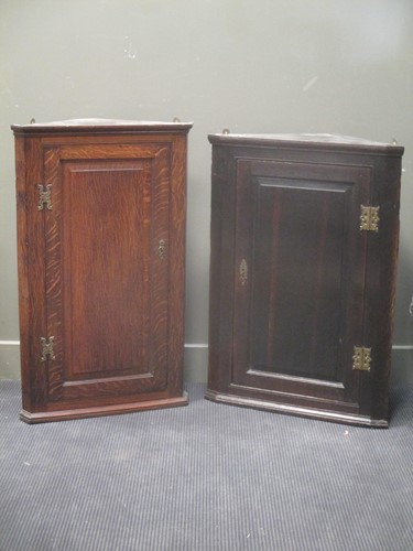 Lot 634 - A Georgian oak corner cupboard 94cm high and...