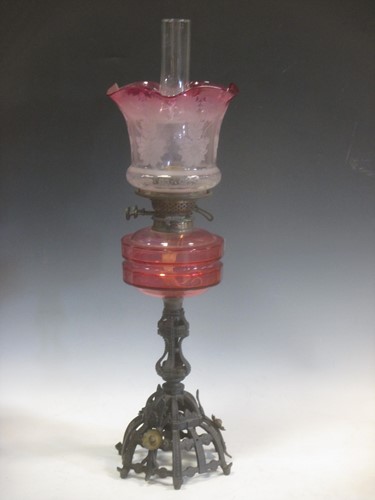 Lot 94 - A Victorian cranberry glass etched oil lamp,...