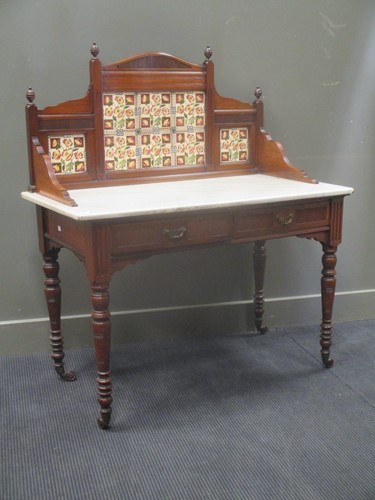 Lot 645 - An Edwardian Shoolbred & Co tile backed...