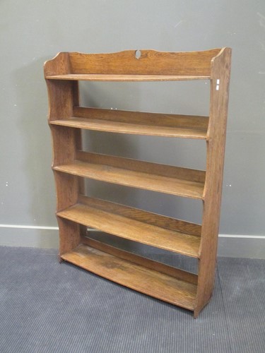 Lot 647 - An Arts & Crafts oak freestanding bookshelf...