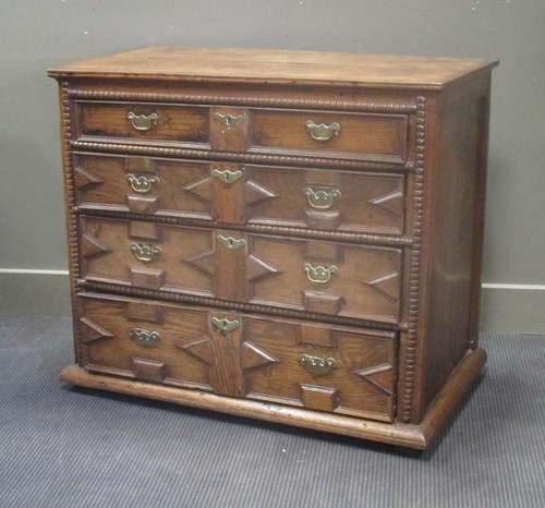 Lot 672 - A 17th century geometric fronted chest of...
