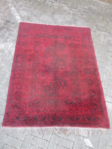 Lot 727 - A red Afghan rug, 210 x 142cm