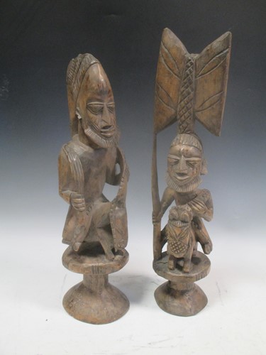 Lot 143 - Two seated African carved equestrian figures,...