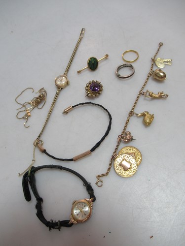 Lot 264 - A charm bracelet tested as 9ct gold with...