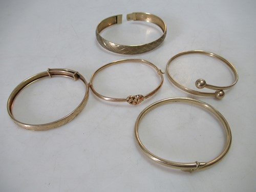 Lot 244 - five gold bangles, tested or hallmarked 9ct...