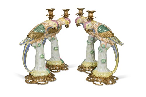 Lot 383 - A set of four gilt metal mounted porcelain parrot candlesticks, modern