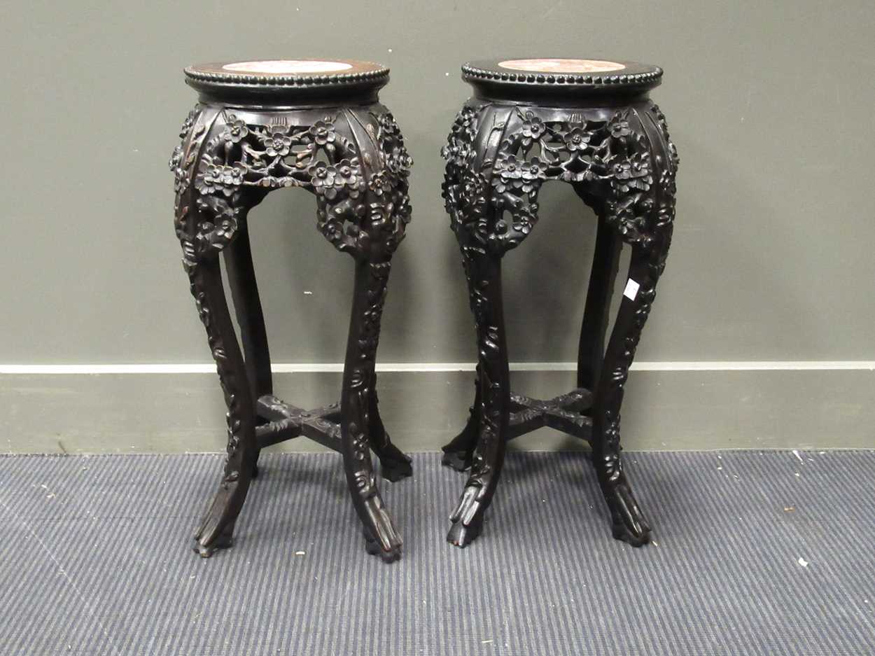 Lot 537 - A pair of Chinese hardwood urn stands with...