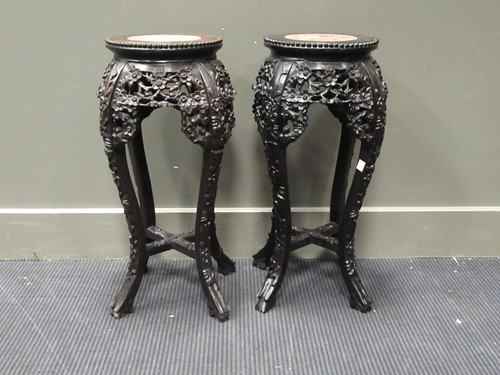 Lot 537 - A pair of Chinese hardwood urn stands with...