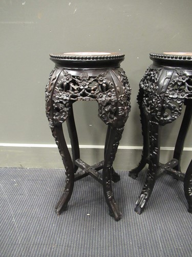Lot 537 - A pair of Chinese hardwood urn stands with...
