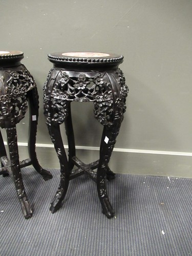 Lot 537 - A pair of Chinese hardwood urn stands with...