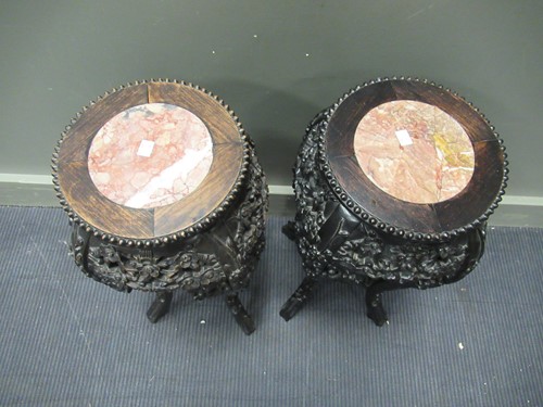 Lot 537 - A pair of Chinese hardwood urn stands with...