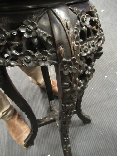 Lot 537 - A pair of Chinese hardwood urn stands with...