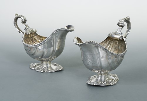 Lot 390 - A near pair of Georgian 18th century cast silver sauce boats