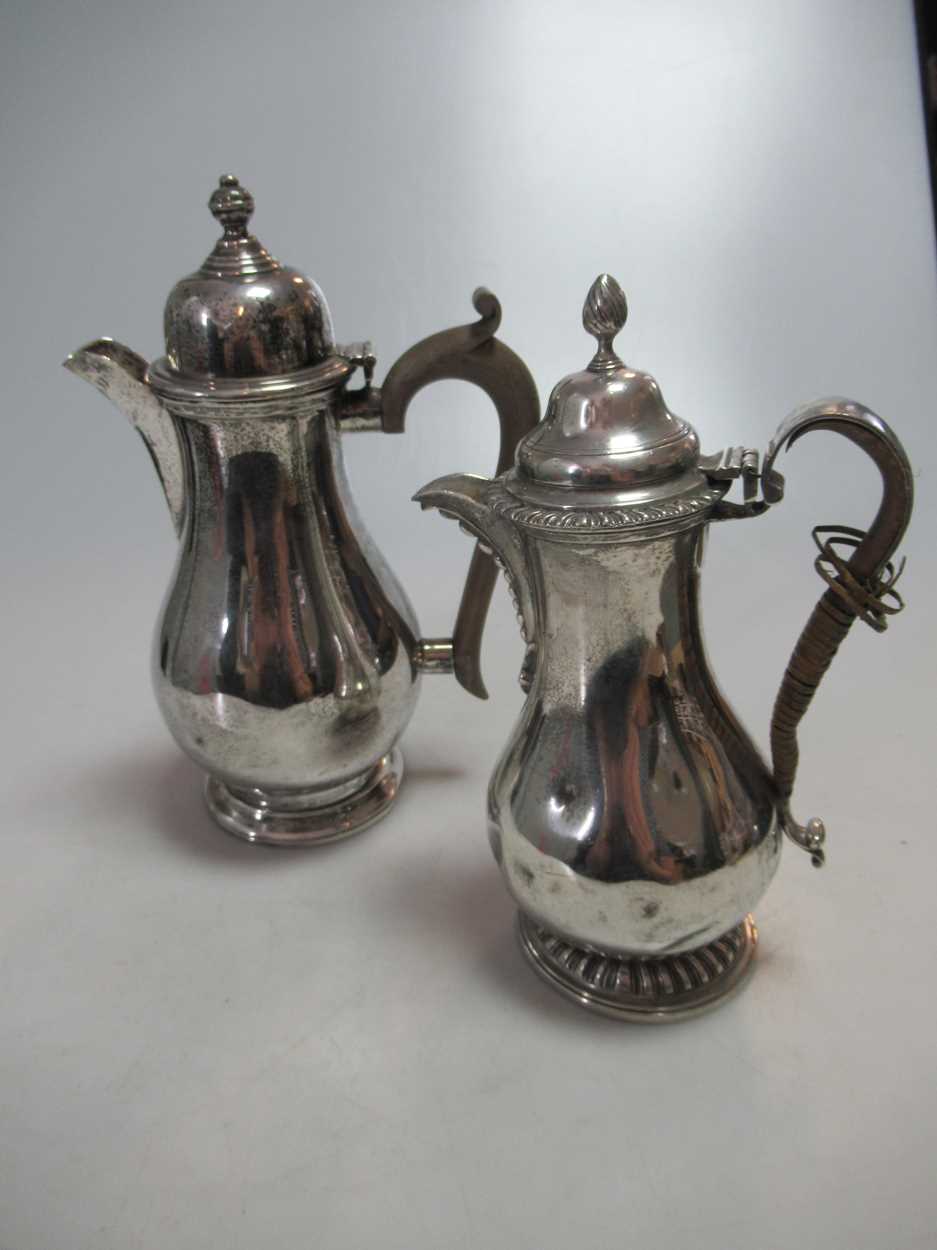 Lot 289 - Two silver hot water jugs, 25.7ozt gross (2)