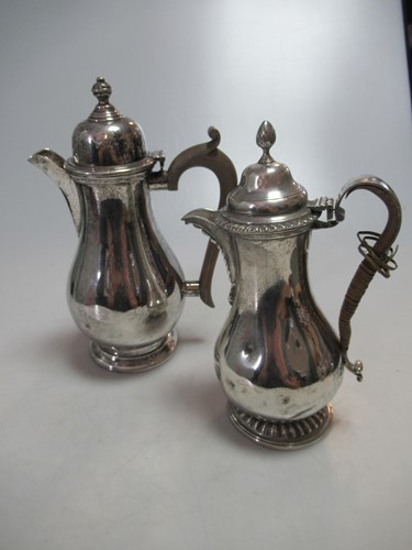 Lot 289 - Two silver hot water jugs, 25.7ozt gross (2)