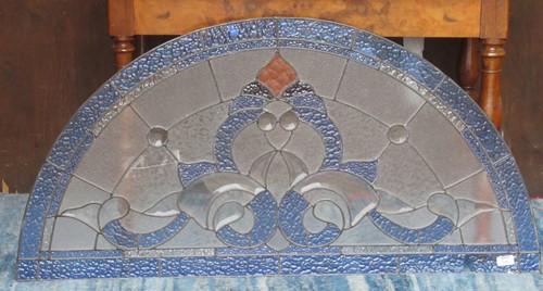 Lot 580 - An arched stained glass panel 61cm high and...