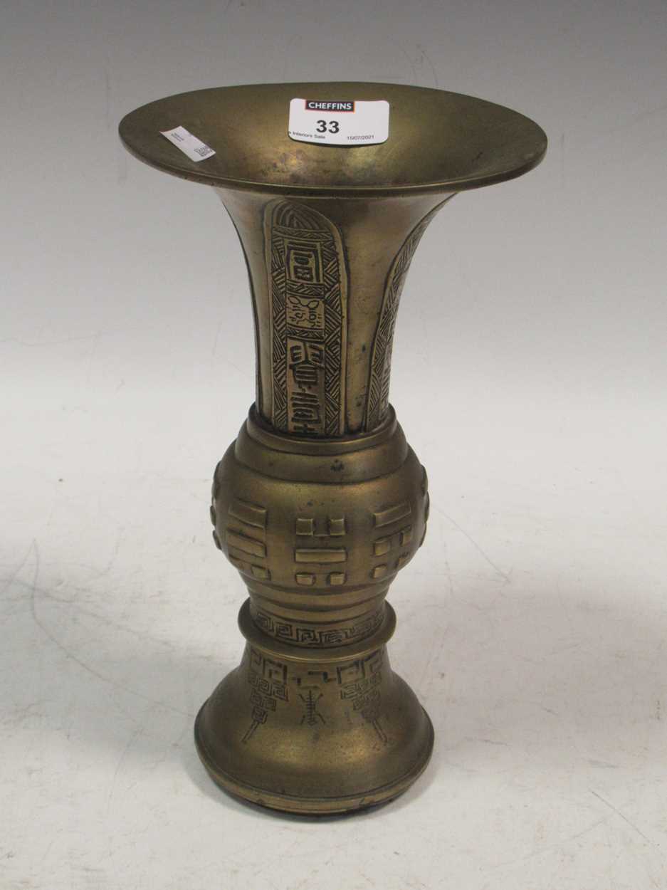 Lot 24 - A Chinese brass or bronze Gu shape vase