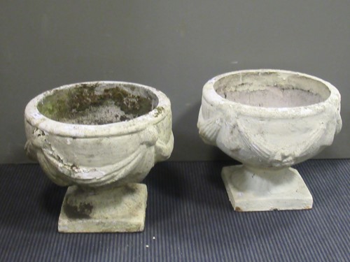 Lot 584 - A near pair of composite garden urns with...