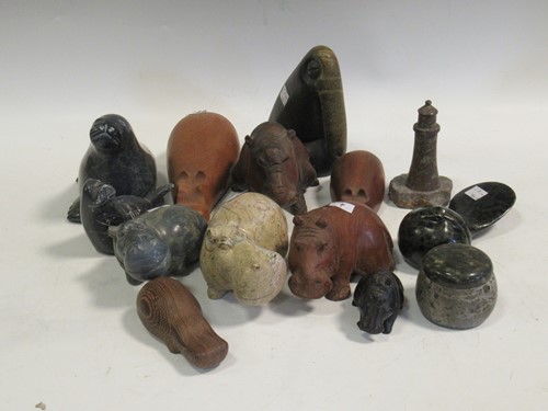 Lot 26 - A collection of stone and wood hippos etc (14)