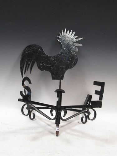 Lot 556 - A black painted metal weather vane surmounted...