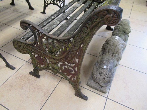 Lot 576 - Two cast iron frame garden benches and a table....