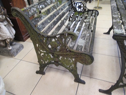 Lot 576 - Two cast iron frame garden benches and a table....