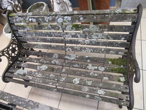 Lot 576 - Two cast iron frame garden benches and a table....