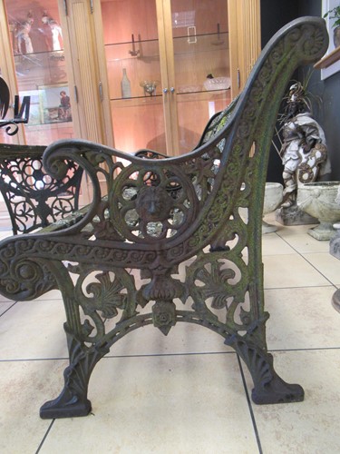 Lot 576 - Two cast iron frame garden benches and a table....