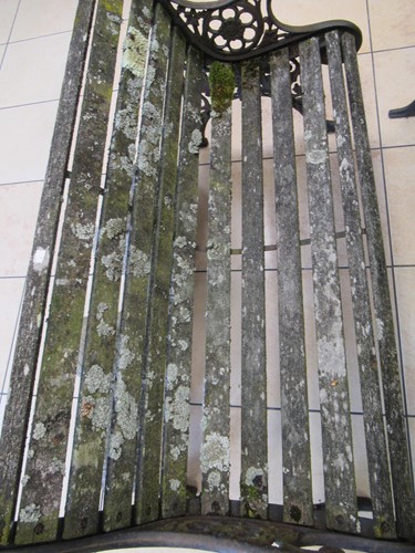Lot 576 - Two cast iron frame garden benches and a table....