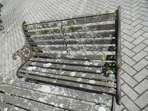 Lot 576 - Two cast iron frame garden benches and a table....