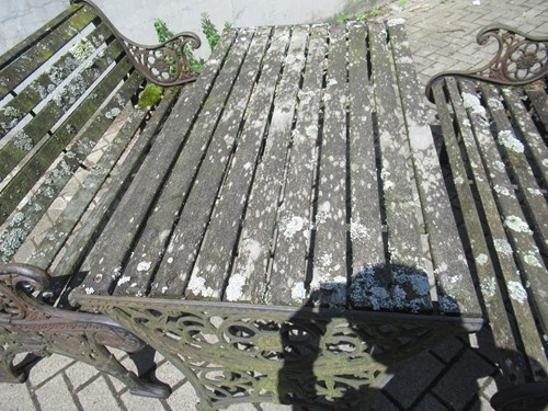 Lot 576 - Two cast iron frame garden benches and a table....