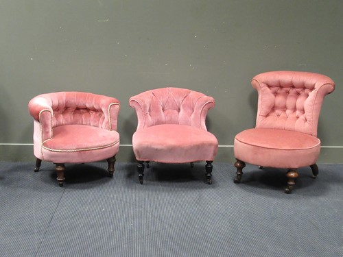 Lot 435 - Three pink upholstered button back low chairs.