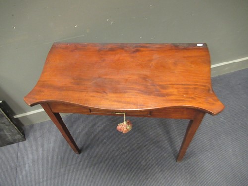 Lot 476 - A mahogany serpentine shape side table with...