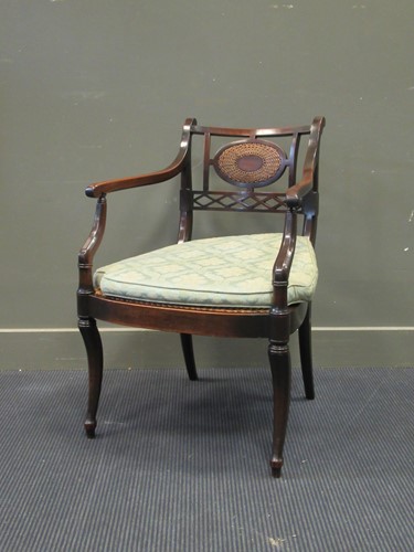 Lot 482 - A George III style mahogany bergere elbow...
