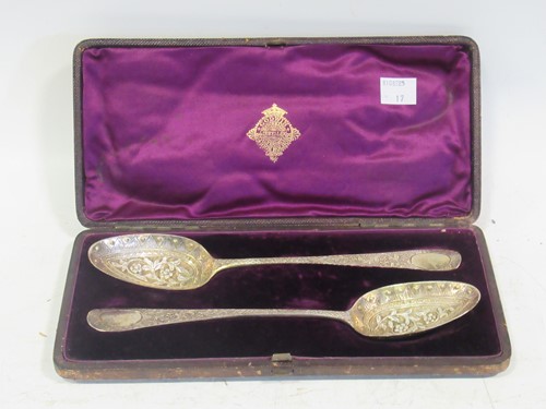 Lot 303 - A cased pair of silver berry spoons