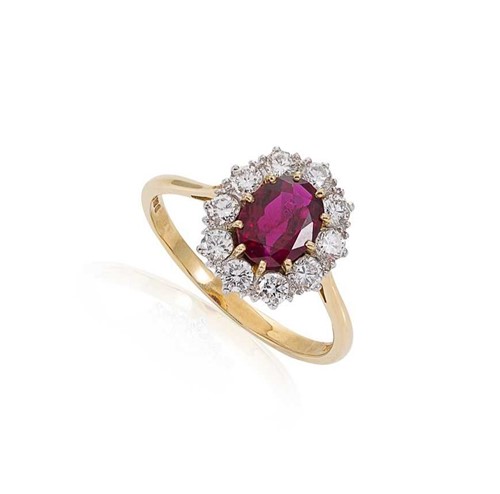 Lot 74 - A ruby and diamond cluster ring set in 18ct gold