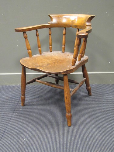 Lot 496 - A smokers bow elbow chair