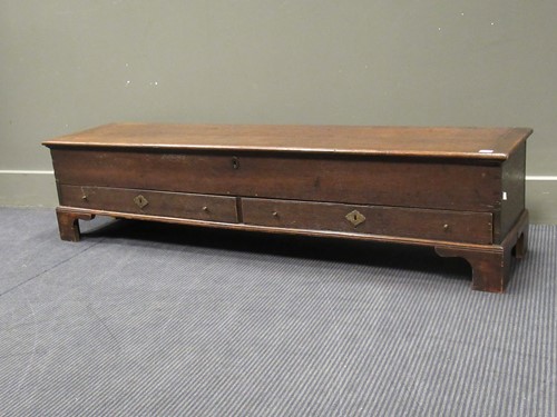 Lot 507 - A low narrow oak coffer with hinged top and...