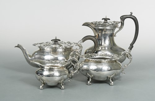 Lot 460 - A George V silver harlequin four-piece tea set